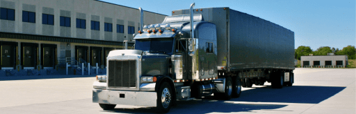 First Frontier Logistics semi-truck at a loading dock, showcasing cross-border freight services between Canada, the USA, and Mexico