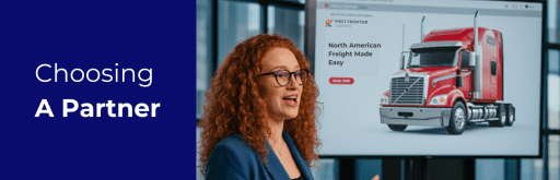 Professional discussing the benefits of choosing First Frontier Logistics as a North American freight partner, with a red semi-truck on display.
