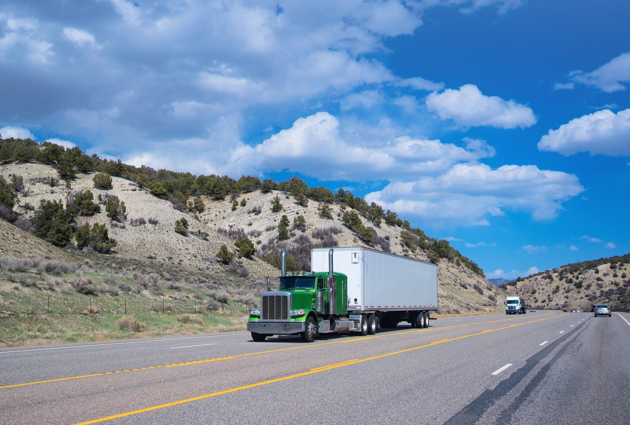 The United States, Mexico and Canada flags are displayed together, symbolizing cross-border shipping under USMCA for full truckload services and less than truckload shipping.