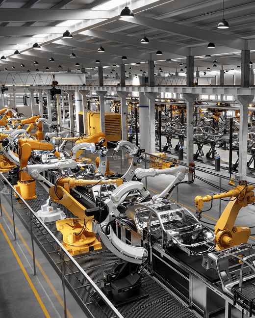 Robotic arms assembling cars in an automotive manufacturing plant
